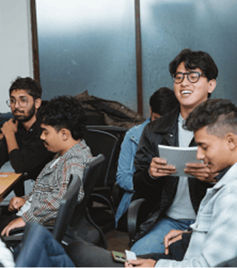 New trainee engaging with team during their entry-level software training.