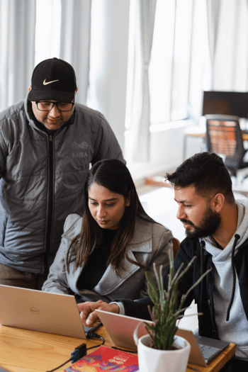 Team collaboration at a software development company, working on custom application features.