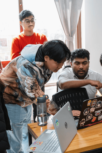 Senior team guiding new hires on agile workflows and best practices in software development.